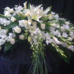 $500- crescent shaped casket with calls, lilies, and orchids. Can be done for less with cheaper flowers 